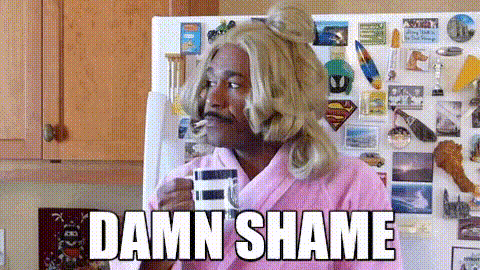 funny man in a pink robe and wig saying "DAMN SHAME"